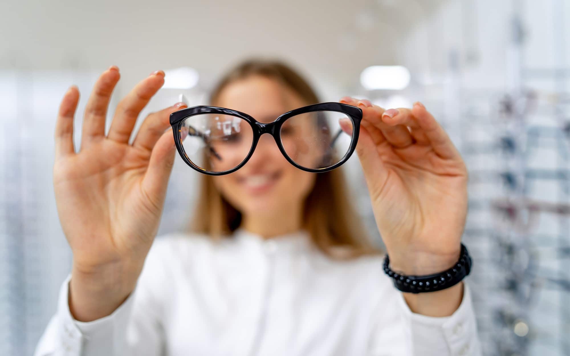 optometrist holding up prescription spectacles
